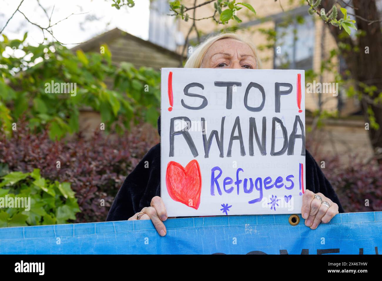 Leeds, UK. 30 APR, 2024. Lady holds "Stop Rwanda, Love refugees" sign