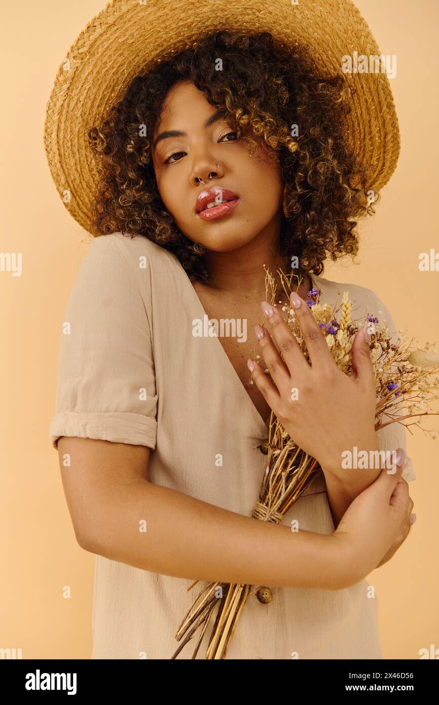 A beautiful young African American woman with curly hair wearing a ...