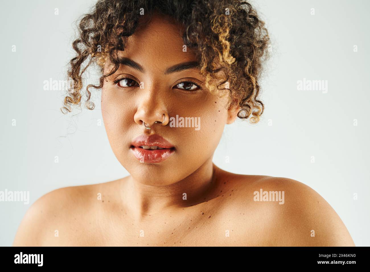 A beautiful African American woman with curly hair striking a pose ...