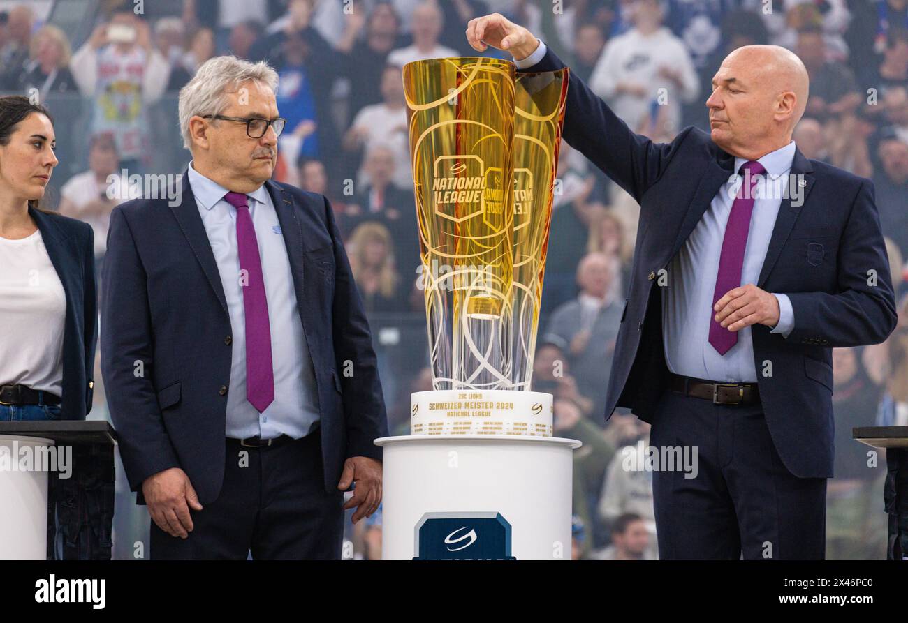 Zurich, Switzerland, 30th Apr 2024: National League CEO Denis Vaucher (right side) drops the puck into the cup with the Swiss champion's name on it. Next to him Willy Vögtlin also from the National League. (Photo by Andreas Haas/dieBildmanufaktur) Credit: dieBildmanufaktur/Alamy Live News Stock Photo