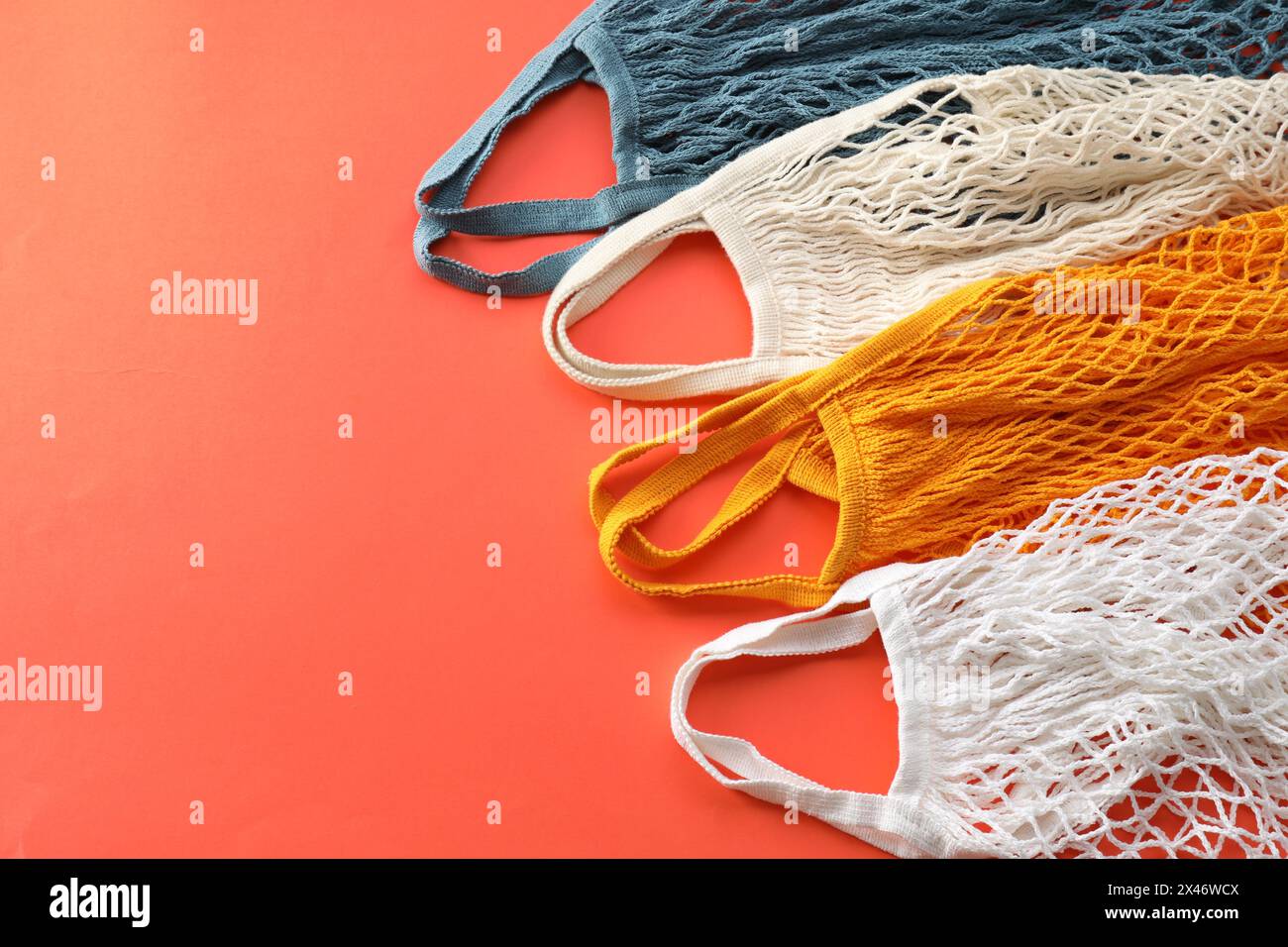 String Bag Asset Different string bags on red background, space for text Stock Photo - Alamy