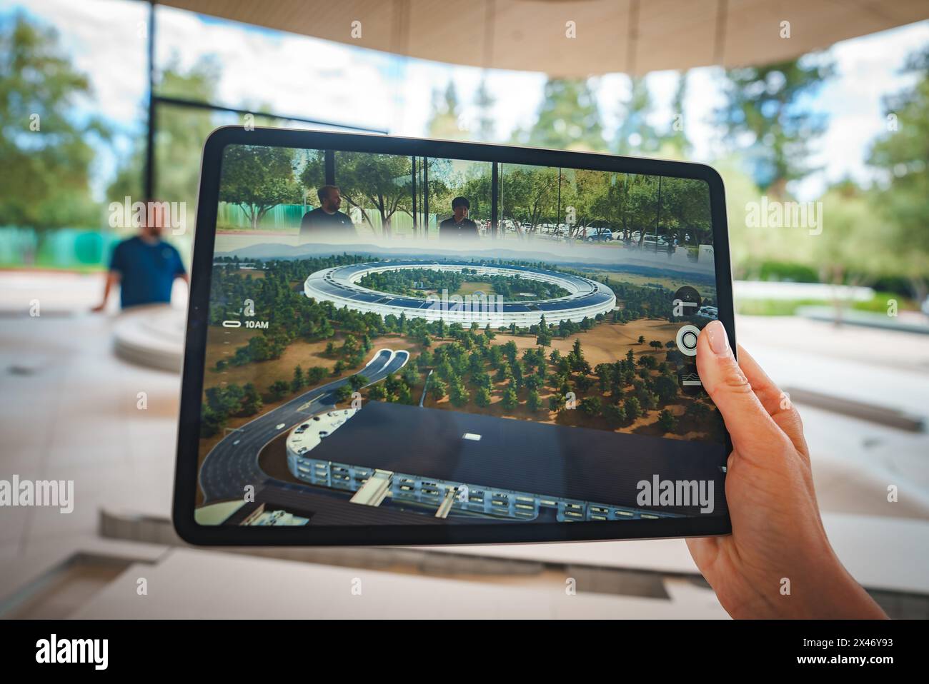 iPad displaying Apple Park, Cupertino, CA indoors, blurred background. Stock Photo