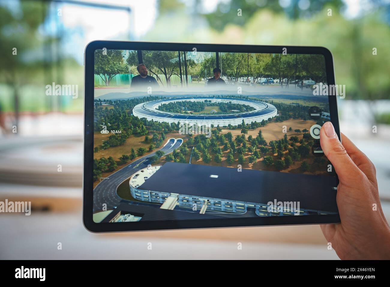 Person holding Apple iPad showing Apple Park in Cupertino Stock Photo