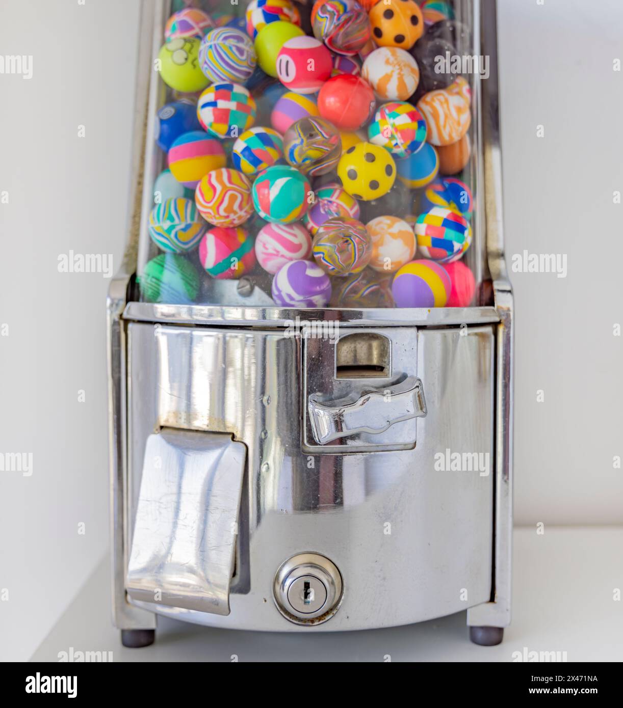 detail image of a coin operated machine that despenses colored rubber balls Stock Photo