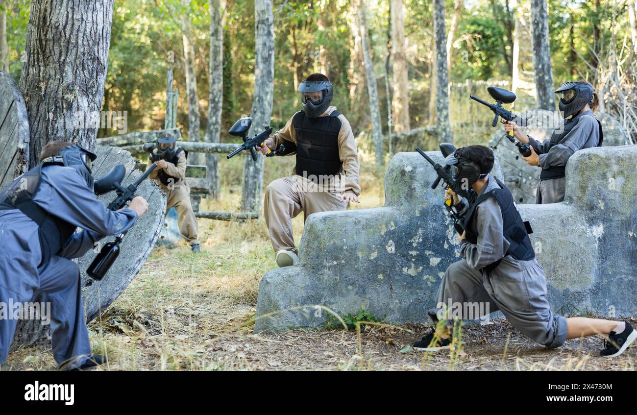 Team of paintball players attacks enemy at an army training ground Stock Photo