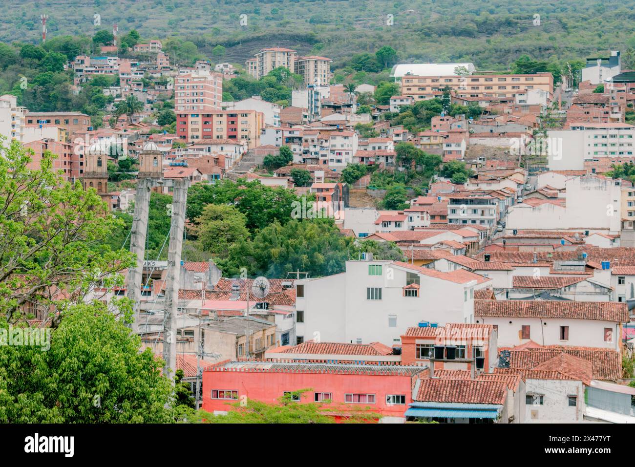 landscape of the city of San Gil, Santander, Colombia from the mountains, with green vegetation in the foreground that highlights the green surroundin Stock Photo