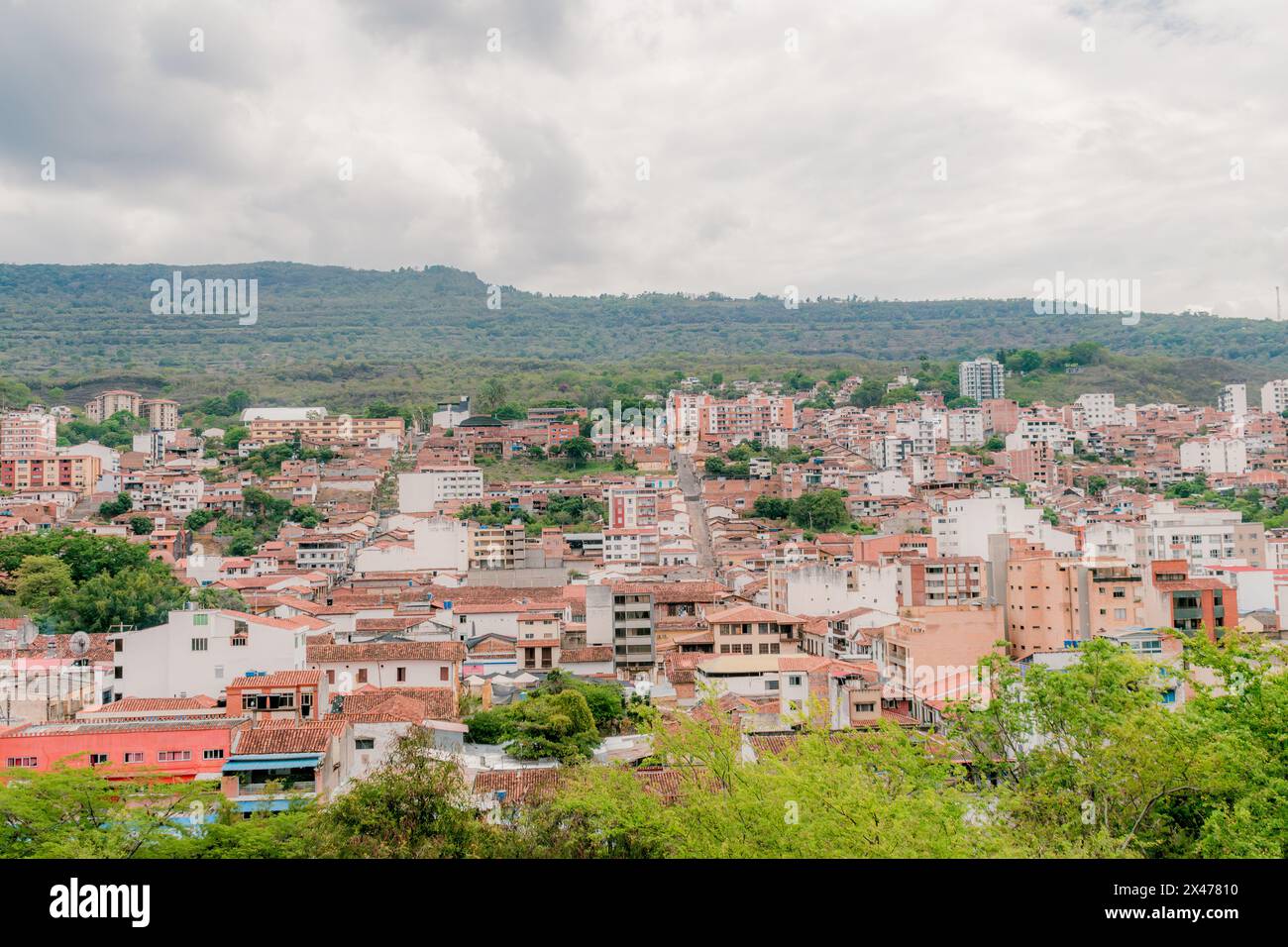 landscape of the city of San Gil, Santander, Colombia from the mountains, with green vegetation in the foreground that highlights the green surroundin Stock Photo