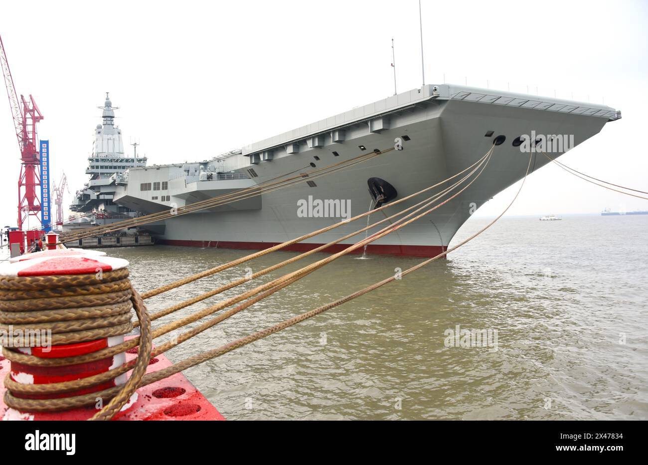 (240501) -- SHANGHAI, May 1, 2024 (Xinhua) -- China's third aircraft carrier, the Fujian, sets out for maiden sea trials from Shanghai Jiangnan Shipyard in east China's Shanghai, May 1, 2024. China's third aircraft carrier, the Fujian, set out for maiden sea trials on Wednesday morning. The ship left Shanghai Jiangnan Shipyard at around 8 a.m. The sea trials will primarily test the reliability and stability of the aircraft carrier's propulsion and electrical systems. Since its launch in June 2022, the Fujian has completed its mooring trials, outfitting work and equipment adjustments. It h Stock Photo