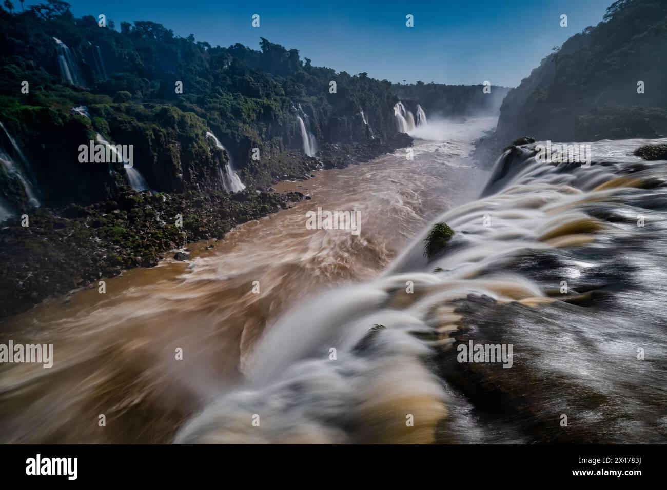 The Iguazú Falls are one of the world’s most awe-inspiring natural sights, with visitors spellbound by its vast scale, thunderous sound, and soaking s Stock Photo