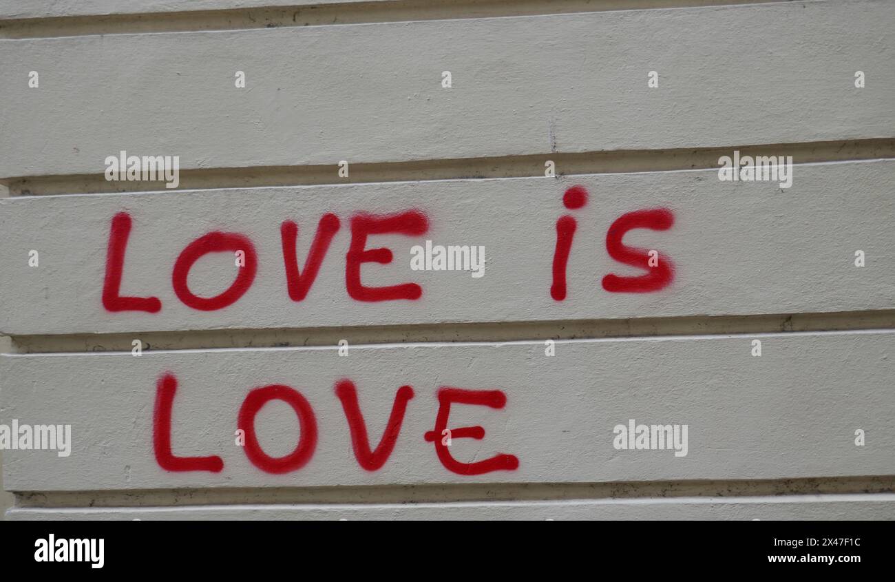 Love is love message painted on public wall Stock Photo