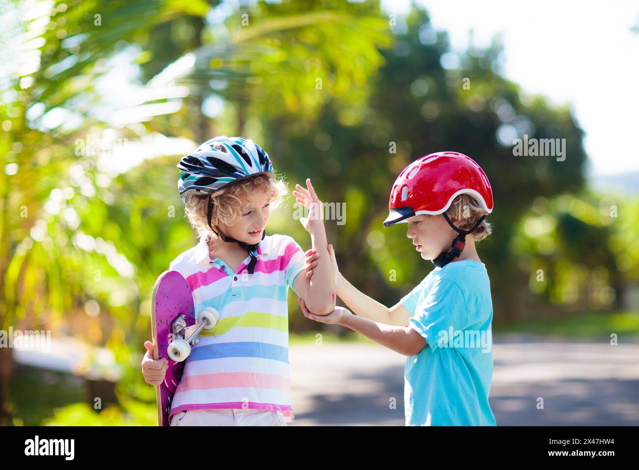 Kids with skate board. Children ride skateboard. Sports safety, fall