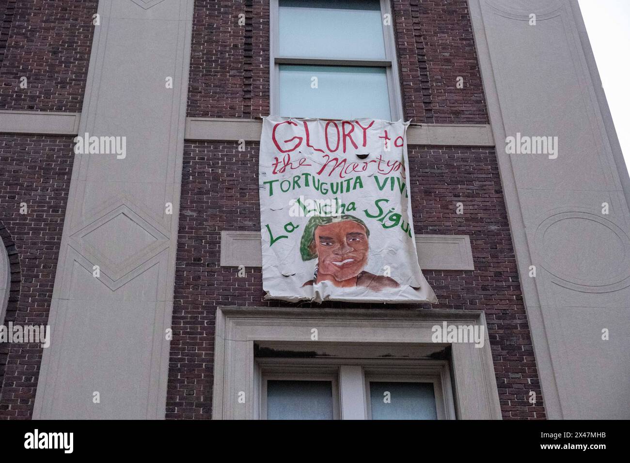 A banner hung from the window of Hamilgton Hall. Reading 