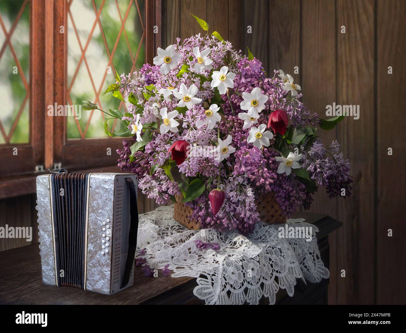 Still life with bouquet of lilac flowers and accordion Stock Photo - Alamy
