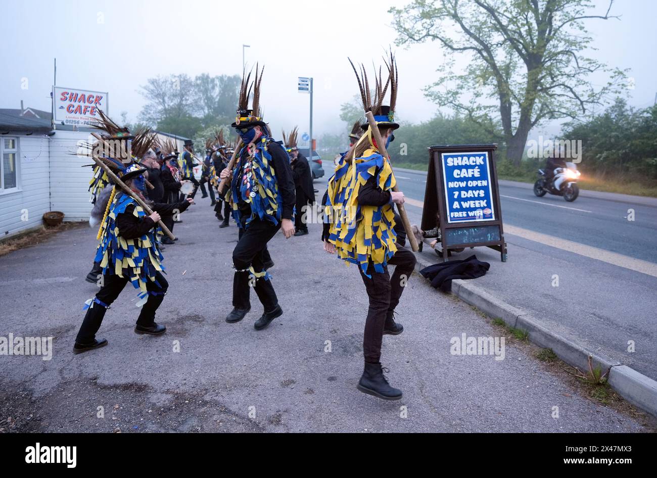 Members of the Hook Eagle Morris perform outside the Shack Cafe near to Hook in Hampshire as they see in the May Day dawn. Picture date: Wednesday May 1, 2024. Stock Photo