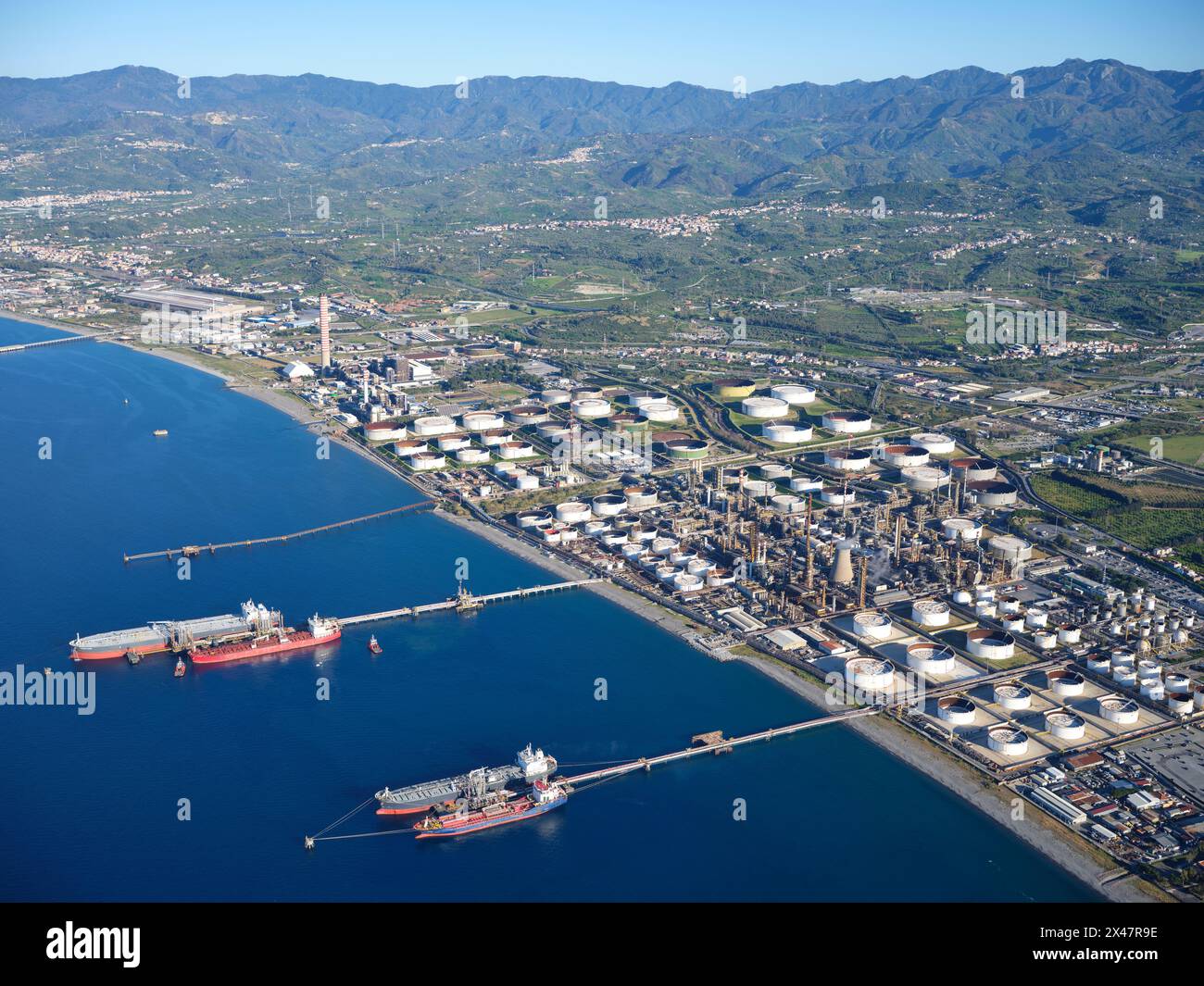 AERIAL VIEW. Large refinery in the city of Milazzo on the Tyrrhenian coastline. Metropolitan City of Messina, Sicily, Italy. Stock Photo