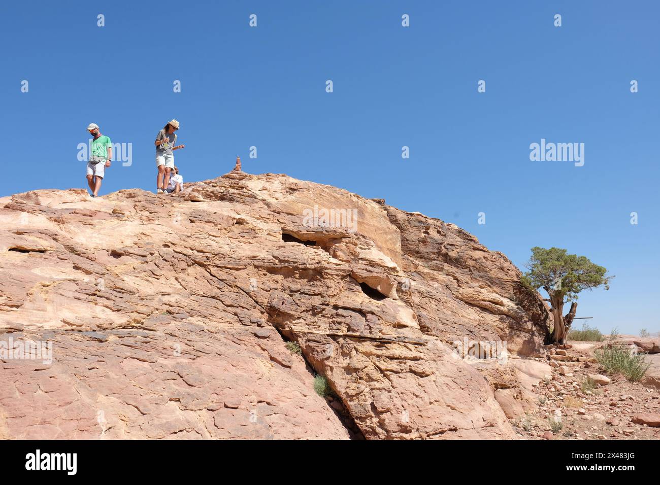 Petra Jordan visitors explore up on the High Place of Sacrifice in the desert  landscape of Petra - August 2023 Stock Photo