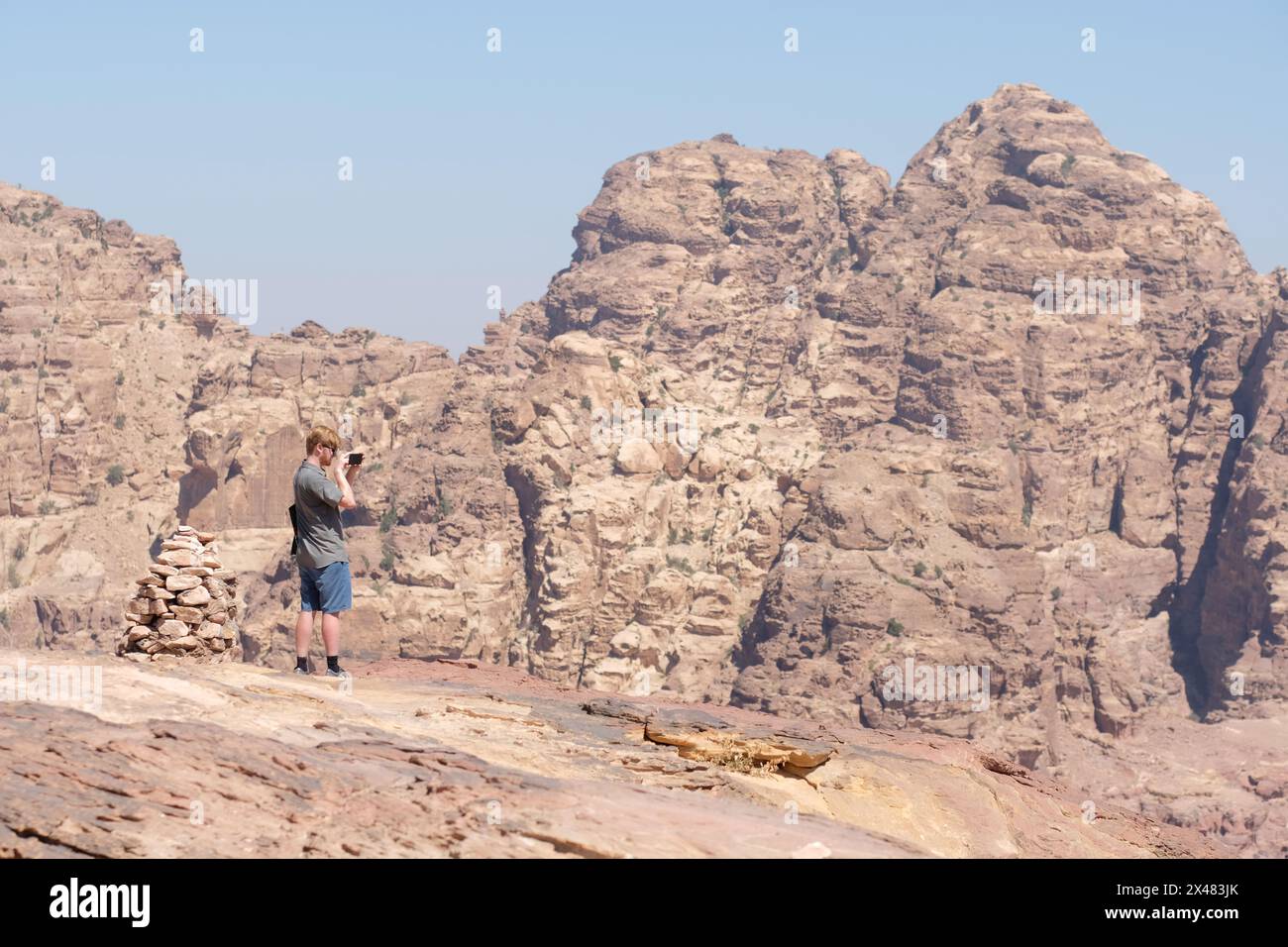 Petra Jordan a visitor admires the magnificent high desert landscape as seen from the High Place of Sacrifice - August 2023 Stock Photo