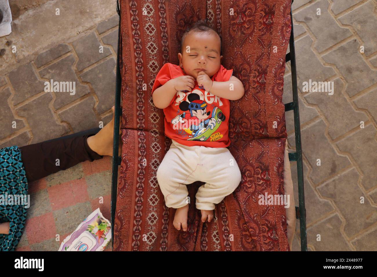 A Palestinian mother and her triplets shelter in their tent at a ...