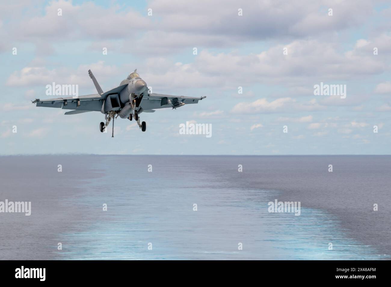 SOUTH CHINA SEA (April 29, 2024) An F/A-18E Super Hornet, attached to the “Flying Checkmates” of Strike Fighter Squadron (VFA) 211, approaches to land Stock Photo