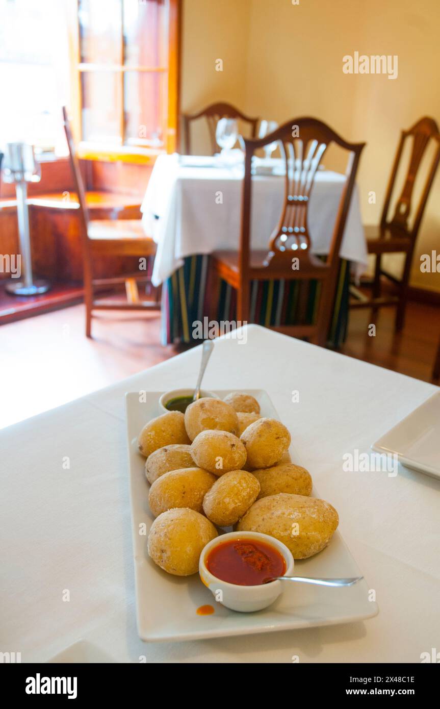 Ration of papas arrugadas with two mojo sauces in a Canarian restaurant. Madrid, Spain. Stock Photo