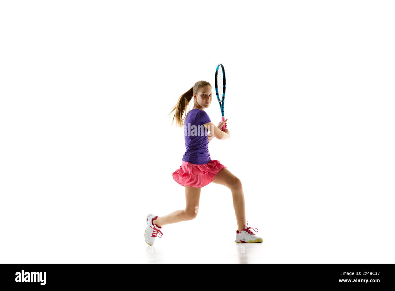 Sporty teenage girl, tennis player in uniform ready to hitting two