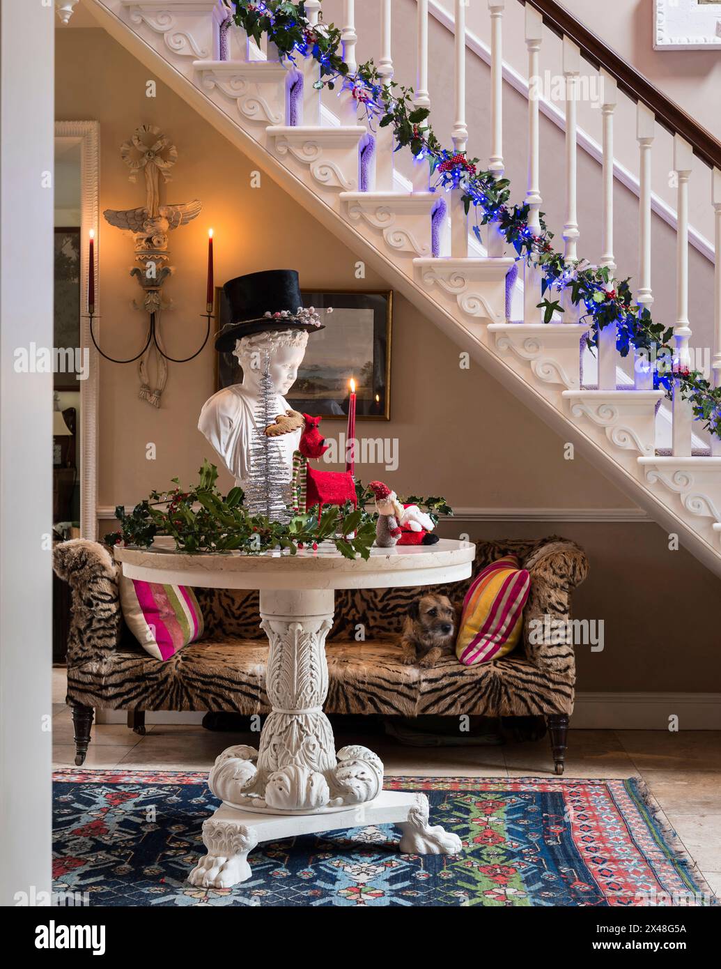 Top hat on bust in entrance hall of Dorset family home at Christmas, England, UK Stock Photo