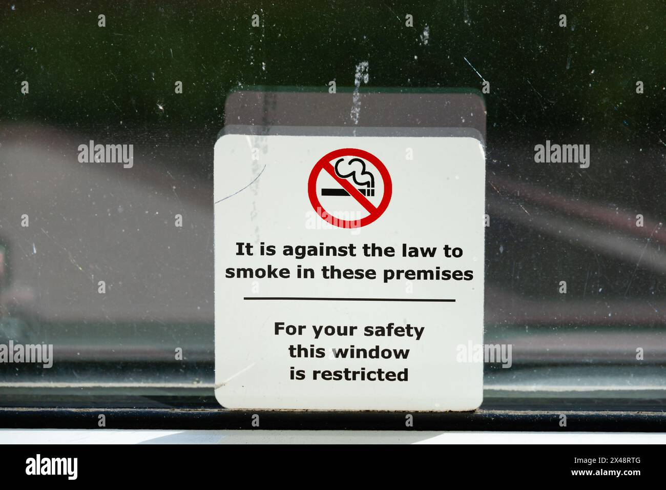 No Smoking, safety restricted sign on dirty window Stock Photo - Alamy