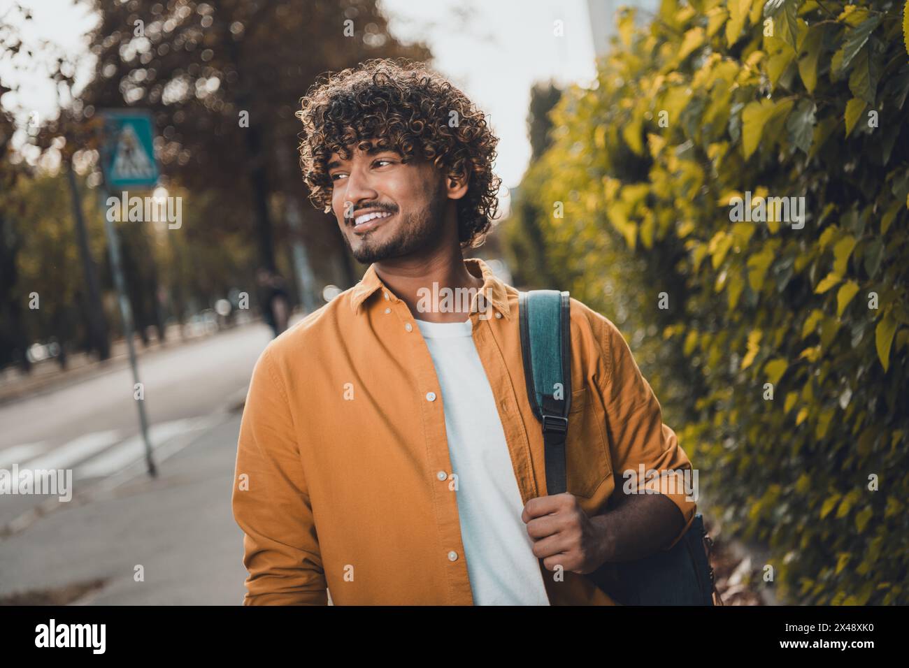 Photo of cheerful indian man wearing stylish clothes going home 