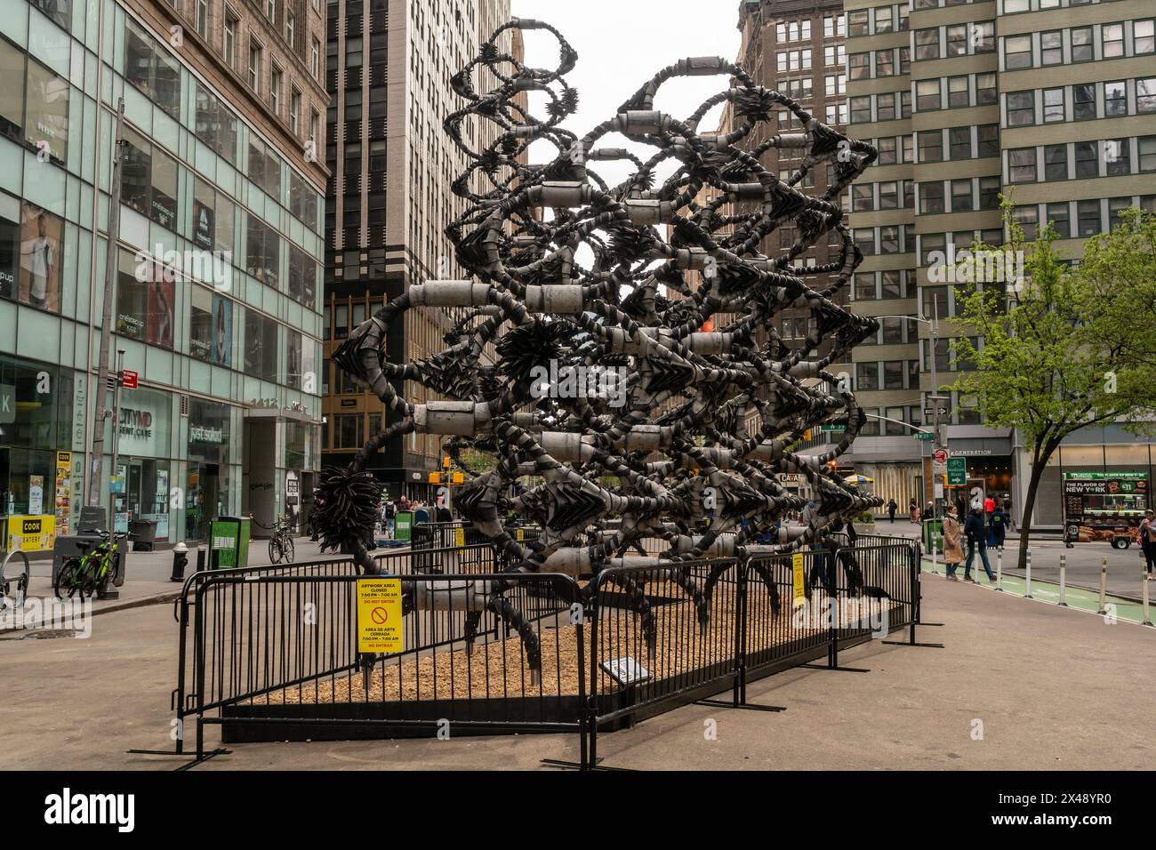 Visitors to the Garment Center in New York on Sunday, April 21, 2024 view “Shaved Portions” by the artist Chakaia Booker.  The sculpture constructed of reused and deconstructed rubber tires will be on display until November 1. (© Richard B. Levine) Stock Photo