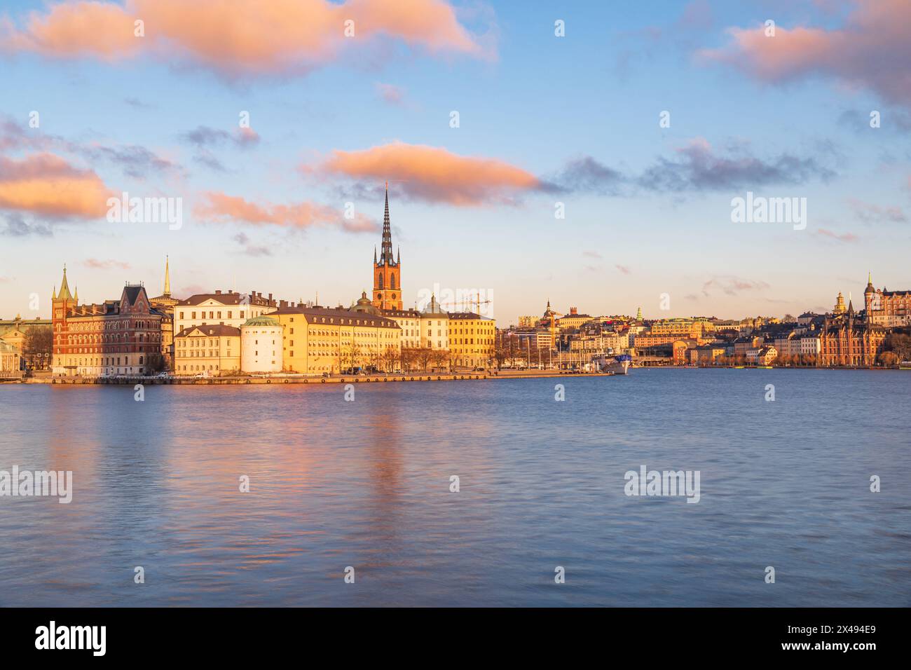 Sunset over Riddarholmen island, Stockholm, Sweden. Medieval buildings, church and clouds. Blue sky, early spring Stock Photo