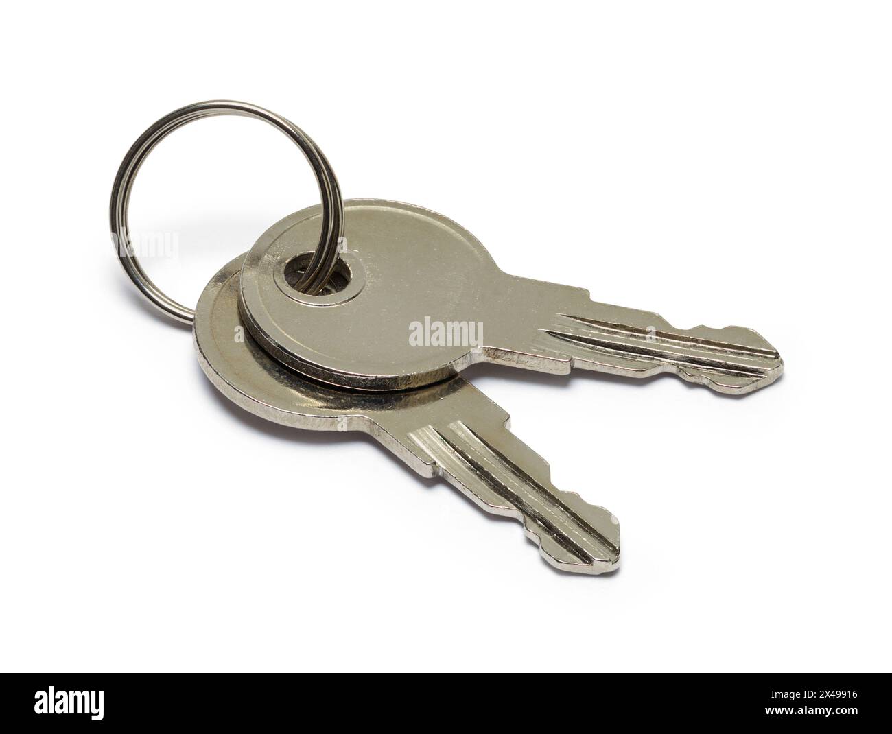 Two Small Keys Cut Out on White. Stock Photo