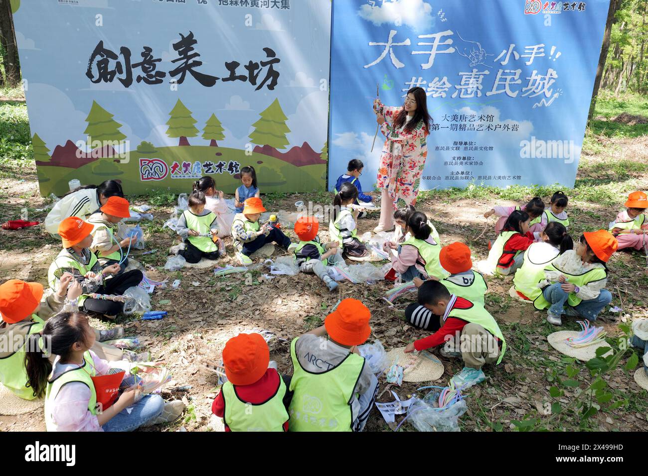 Beijing, China's Shandong Province. 1st May, 2024. Children make handicrafts with the instruction of a teacher at a forest park in Huimin County of Binzhou, east China's Shandong Province, May 1, 2024. Credit: Fan Changguo/Xinhua/Alamy Live News Stock Photo