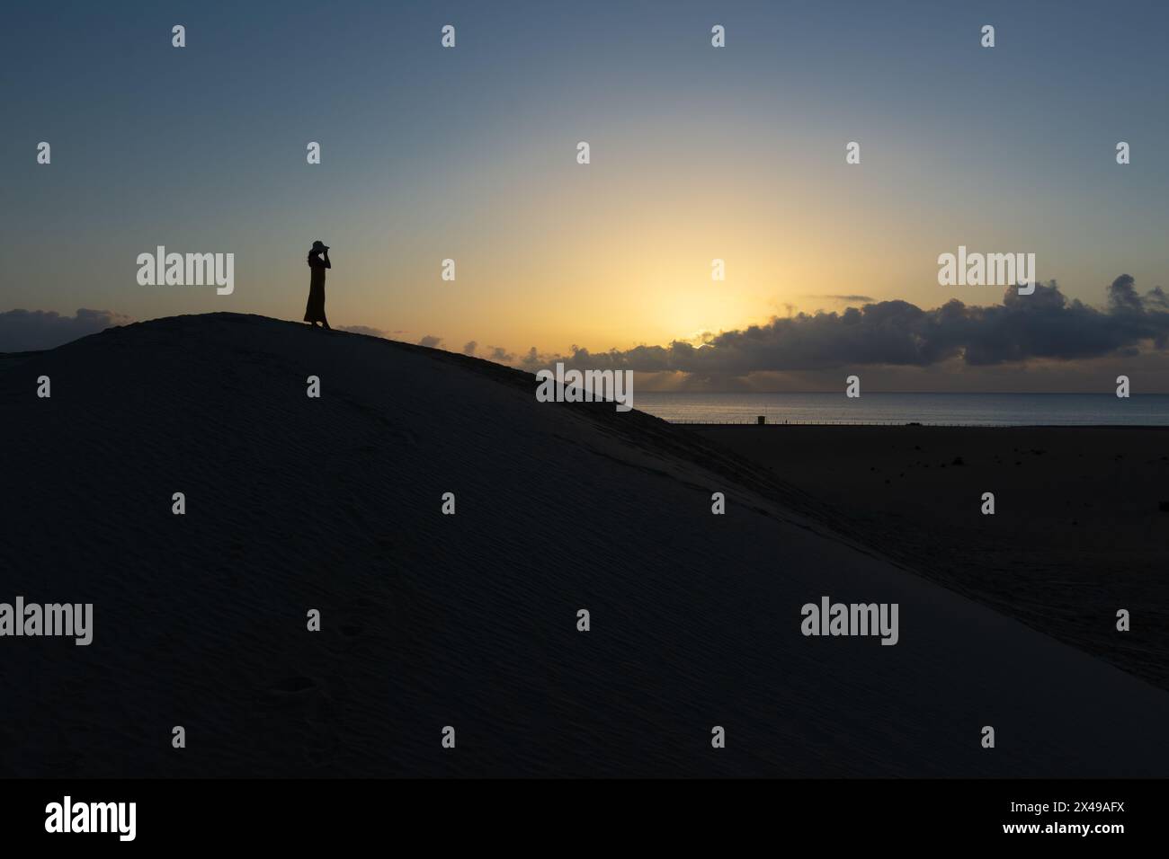 Woman watching sunset in desert hi-res stock photography and images - Alamy