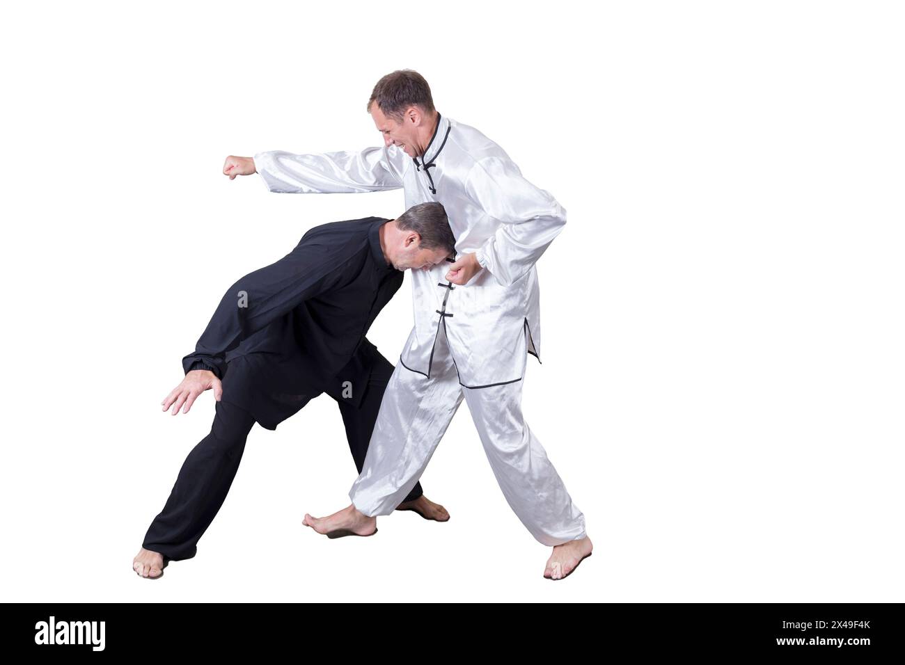 Adult athlete performs formal goju-ryu exercises. It is isolated in a white background. Close-up. Stock Photo