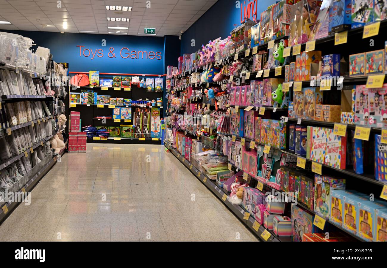 Looking down shop aisle of kids merchandise to sign for toys & games Stock Photo