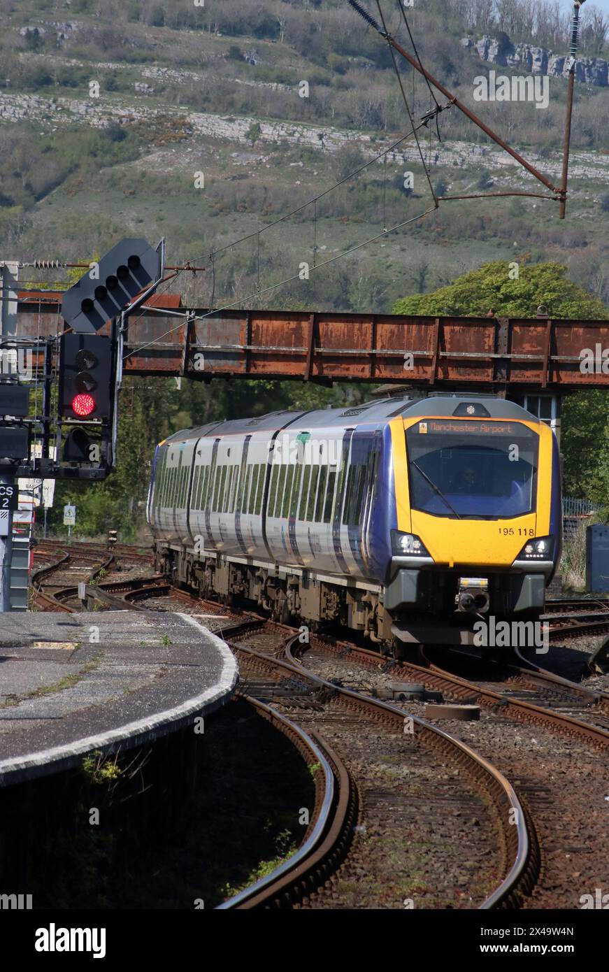 Two Northern trains class 195 civity diesel multiple-units arriving at Carnforth station with train to Manchester Airport on 1st May 2024. Stock Photo