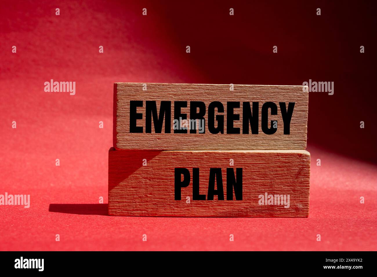 Emergency plan words written on wooden blocks with red background. Conceptual emergency plan symbol. Copy space. Stock Photo