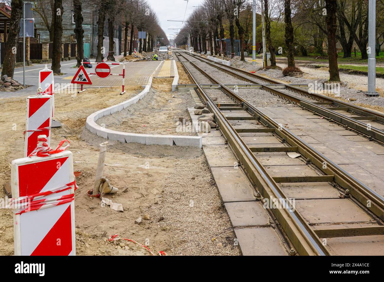 Unfinished construction of a modern low-floor tram stop and replacement of tram rails on a city street Stock Photo