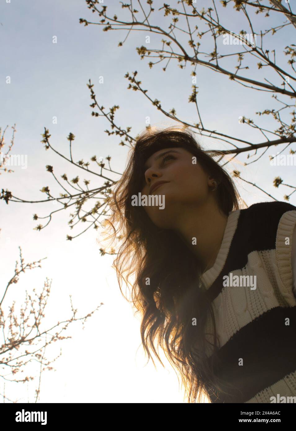 Girl looking at sky spring sunny pretty girl picture in front of the sky and sun Stock Photo