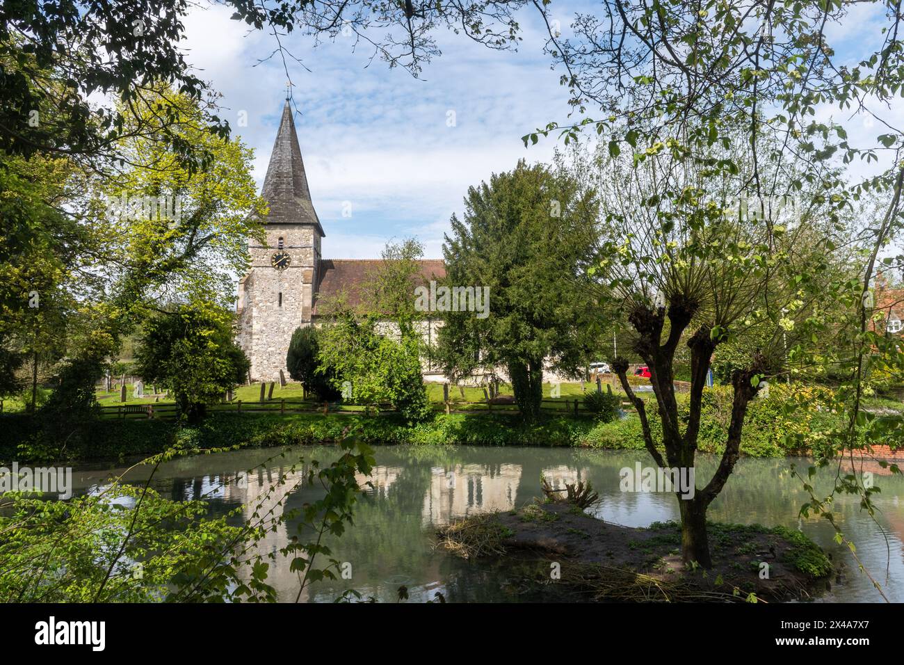 View of Holy Rood Church and village pond in Holybourne, Hampshire, England, UK Stock Photo