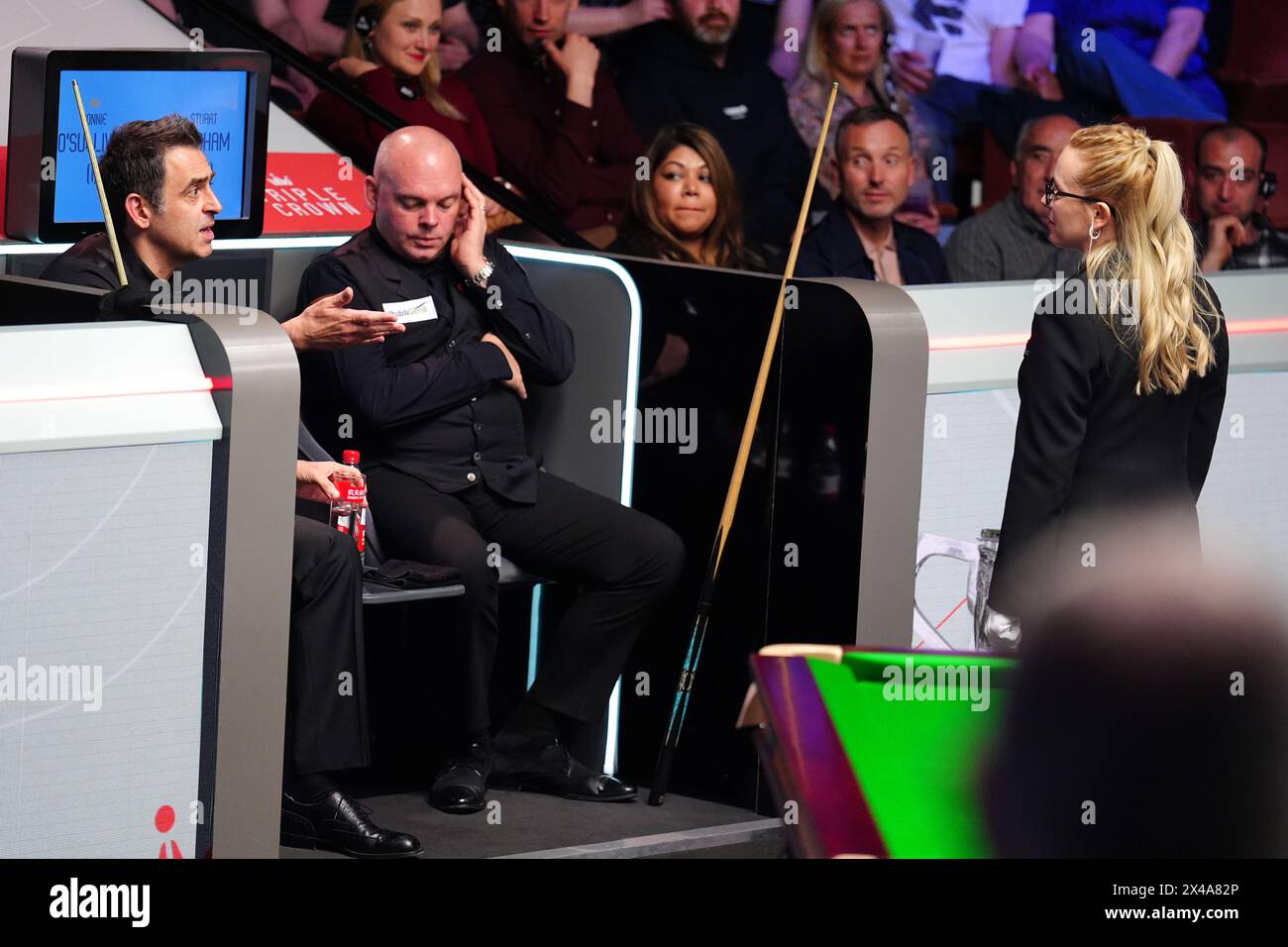 Ronnie O'Sullivan (left) speaks to referee Desislava Bozhilova (right) during a break in play due to some members of the crowd still getting to their seats in the quarter-finals match against Stuart Bingham on day twelve of the 2024 Cazoo World Snooker Championship at the Crucible Theatre, Sheffield. Picture date: Wednesday May 1, 2024. Stock Photo