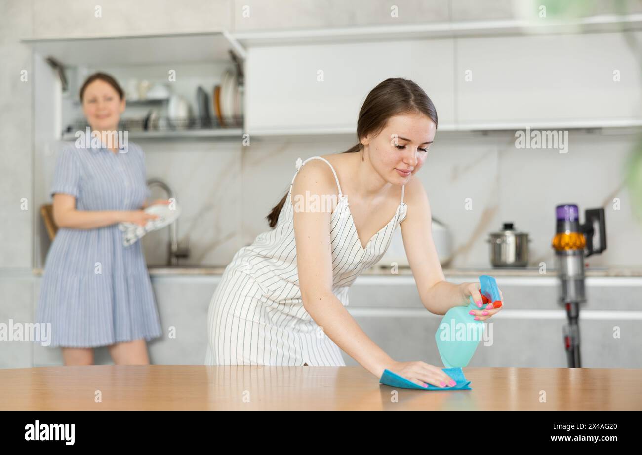 Daughter dusting table mother hi-res stock photography and images - Alamy