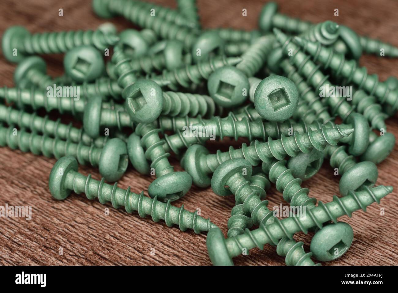 Green ceramic coated wood screw button head. Wood screw protected