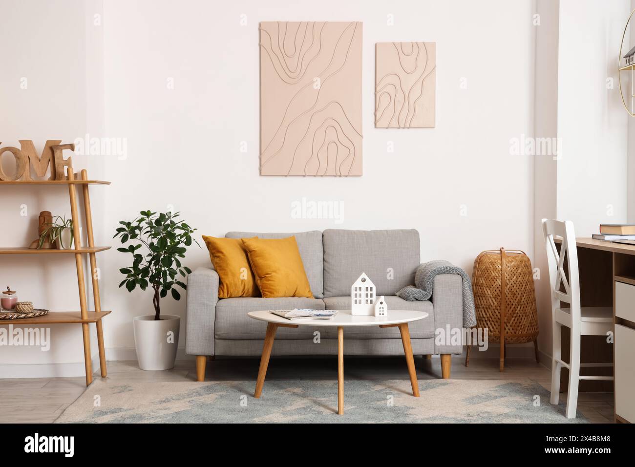Interior of stylish living room with grey sofa, coffee table and ...