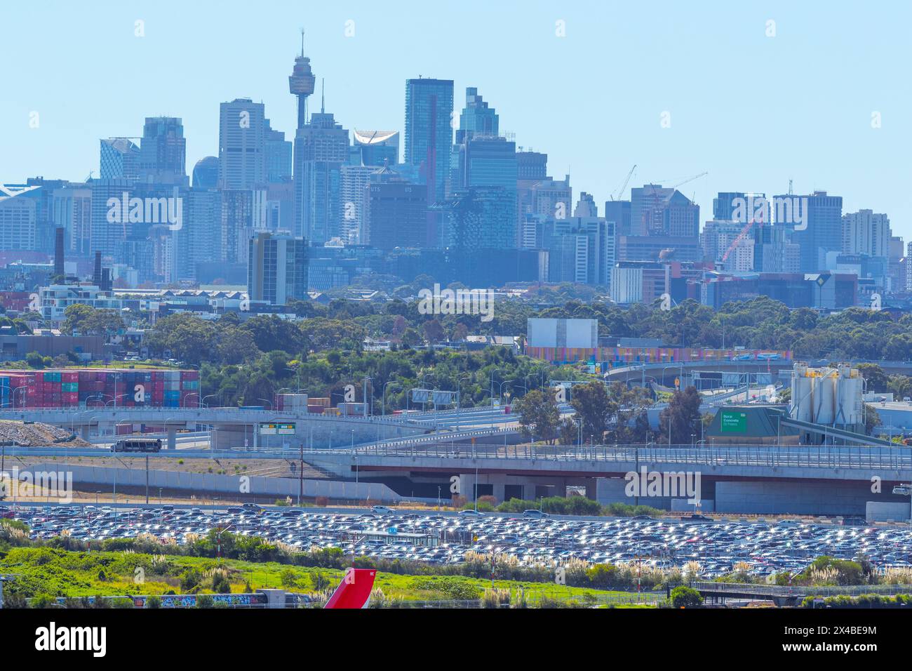 The Sydney skyline seen from Sydney Airport in Australia. The Sydney Gateway, creating new roads into the airport, can be seen in the middle-ground. Stock Photo