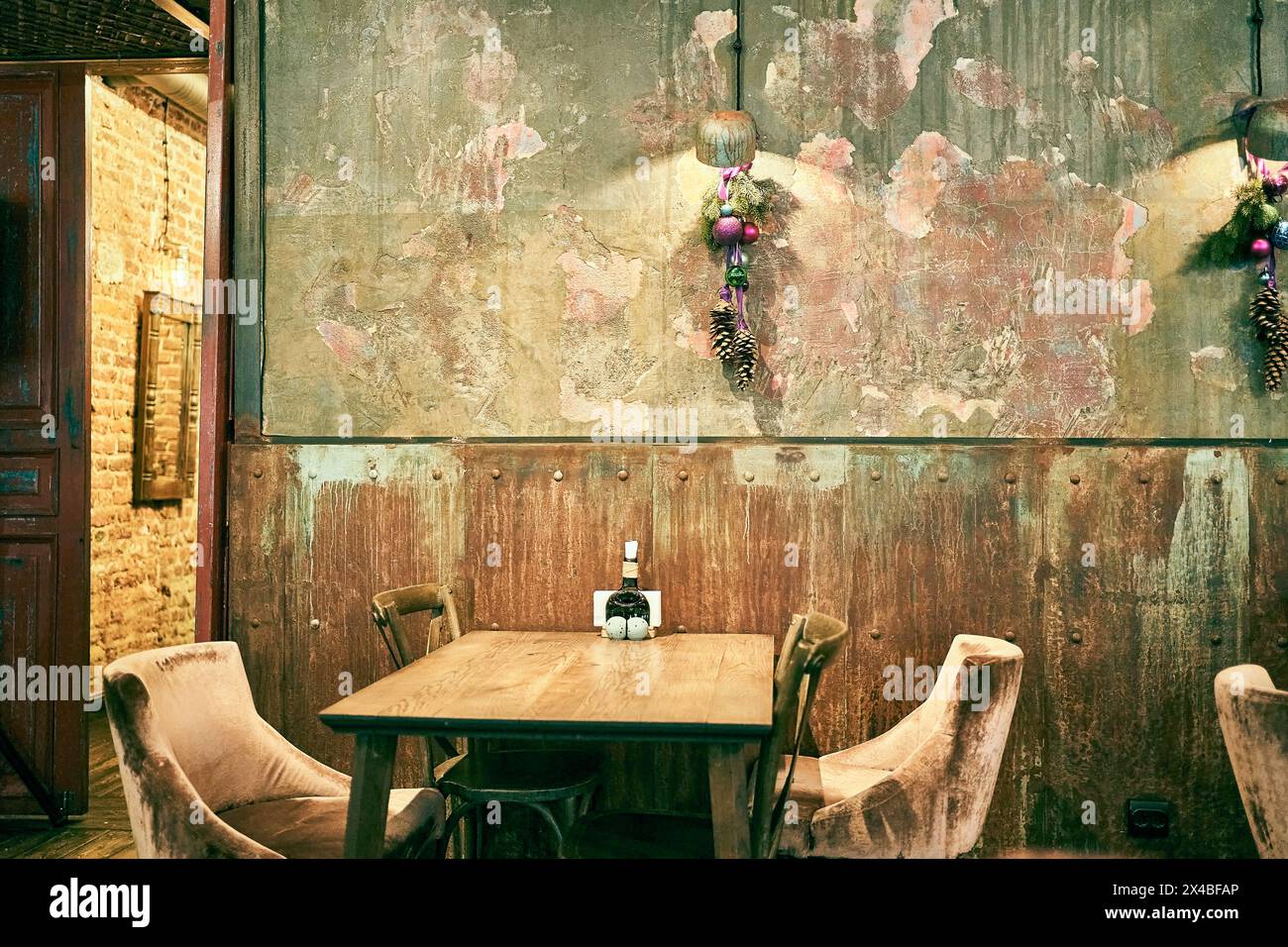 A spectacular photo of a wooden table and upholstered chairs in the bar. Shabby walls with space to copy. High quality photo Stock Photo