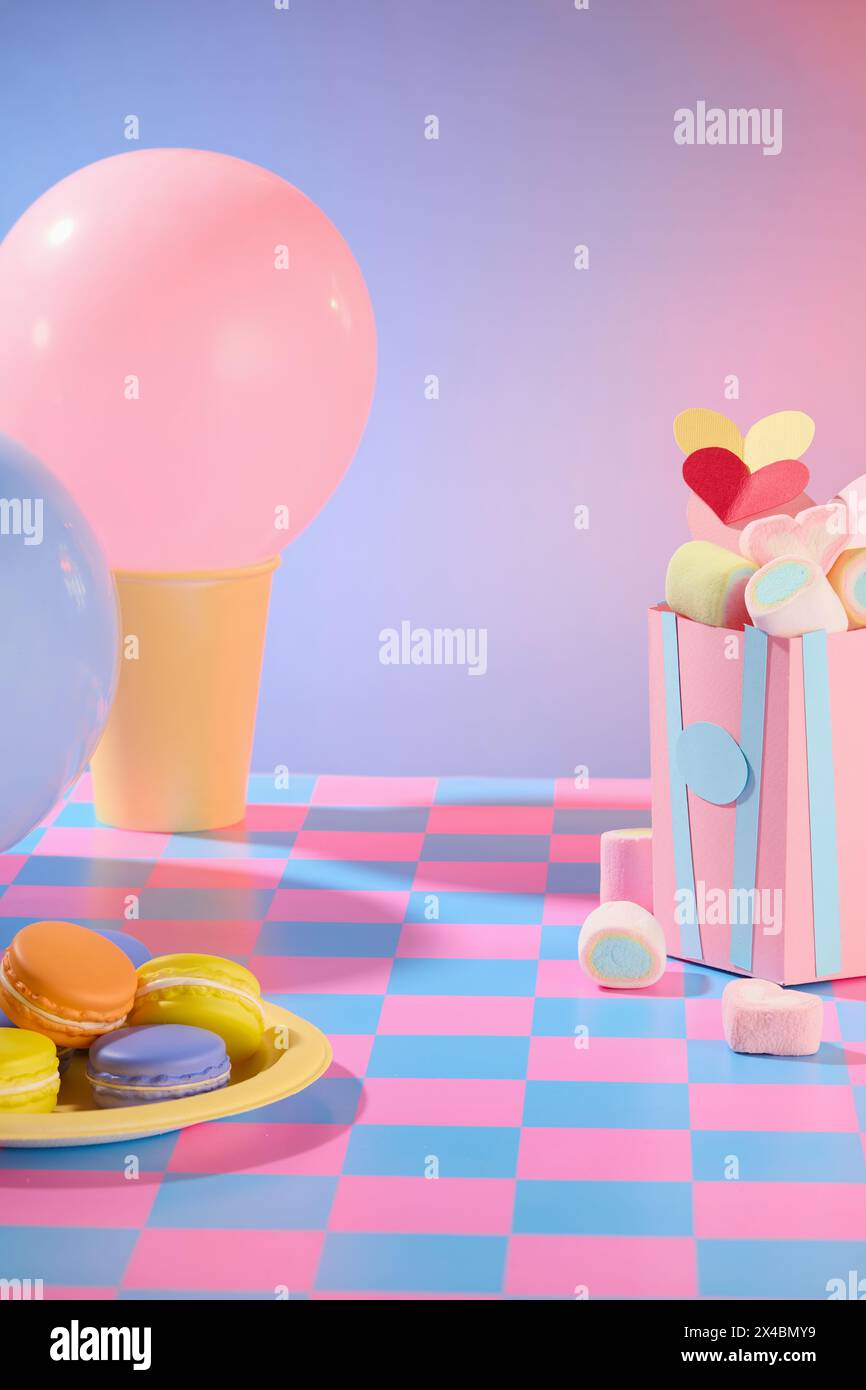Purple gradient background with yellow dish of cake and box filled with sweet marshmallow decorated. Empty space for design and add text. Valentine’s Stock Photo