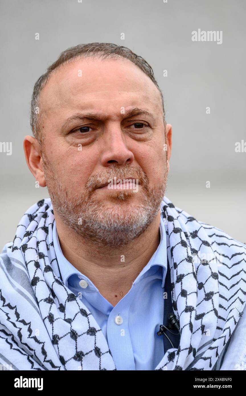 Dr. Husam Zomlot - Palestinian Ambassador to the UK - wearing the black and white keffiyeh (scarf) at the London May Day March, in Trafalgar Square Stock Photo
