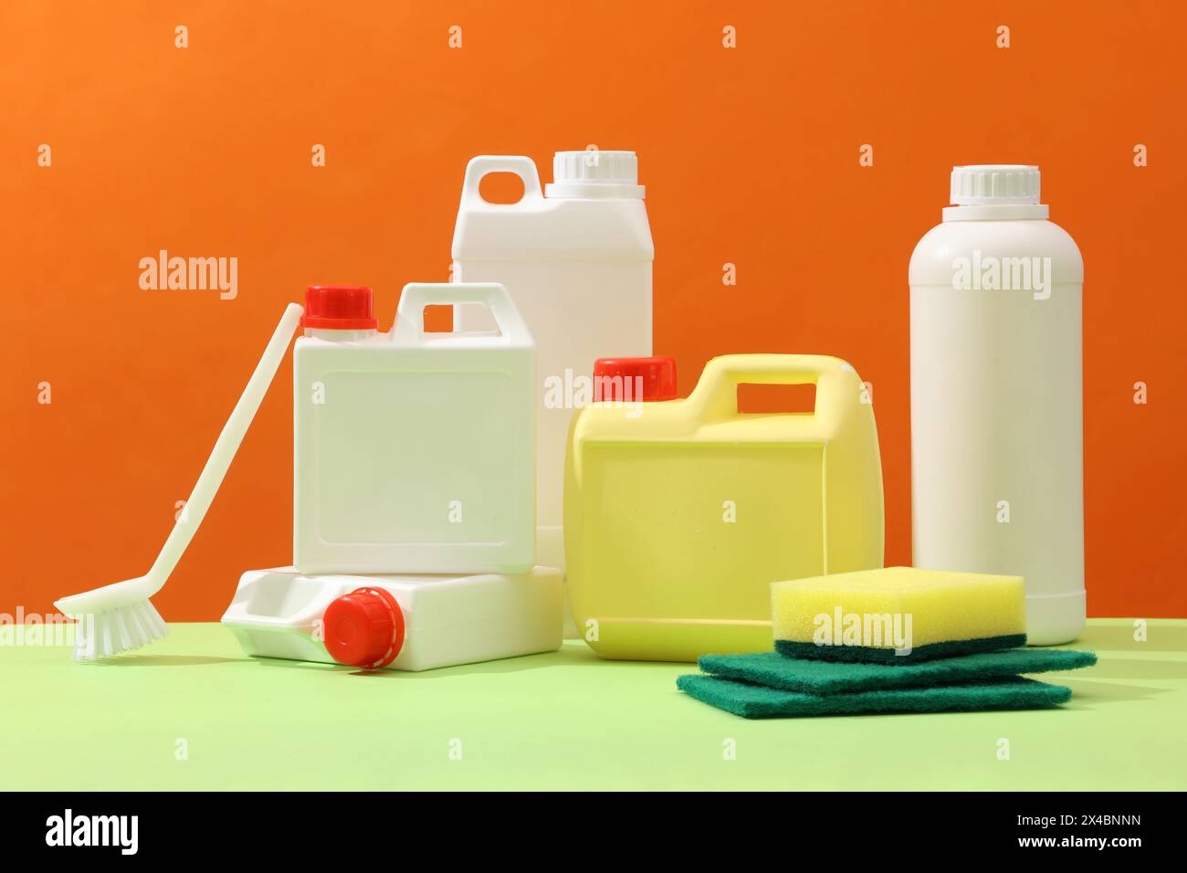 Set of different detergent canisters and bottles decorated with sponges