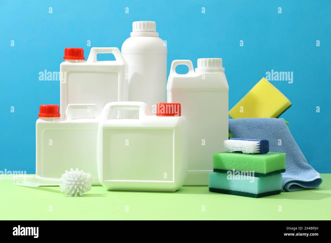 Set of different detergent canisters displayed with brushes, sponges